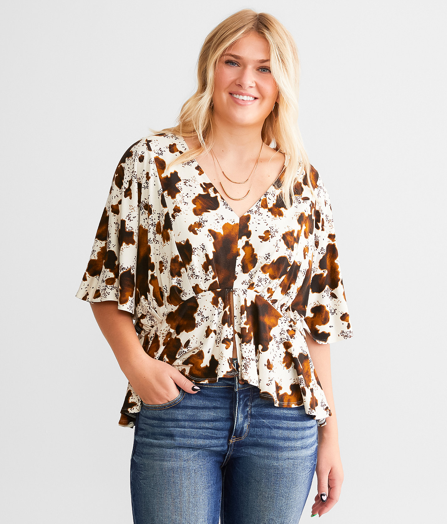 Daytrip Cow Print Split Peplum Top - Women's Shirts & Blouses in Cream Brown